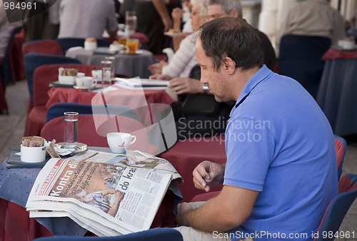 Image of Man reading newspaper