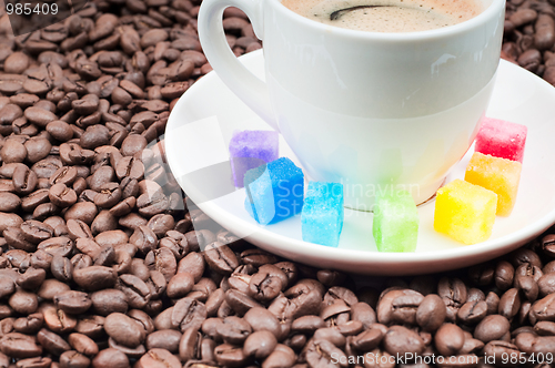 Image of Multicolored slabs of shugar and cup of coffee