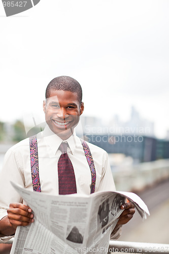 Image of Businessman reading newspaper