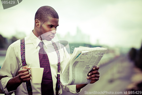 Image of Businessman reading newspaper