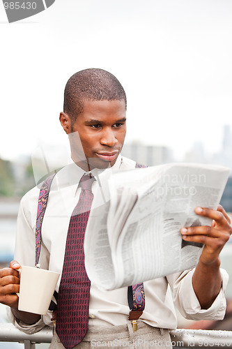 Image of Businessman reading newspaper