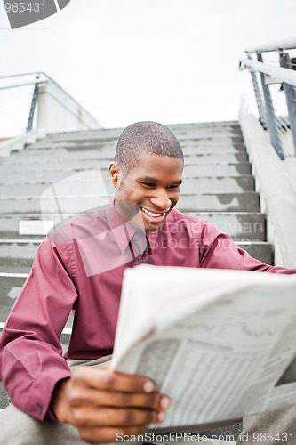 Image of Businessman reading newspaper