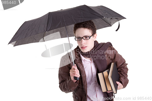 Image of Young boy with an umbrella carrying books