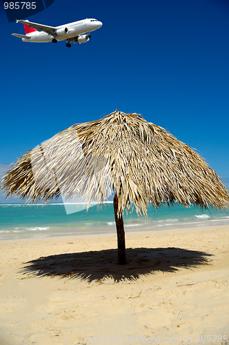 Image of Parasol on beach and plane