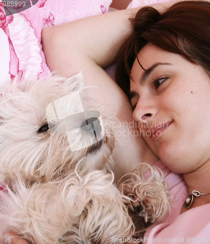 Image of Dog sleeping on bed 