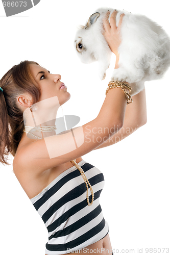 Image of Pretty young woman playing with rabbit