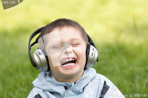 Image of Portrait of laughing boy in headphones