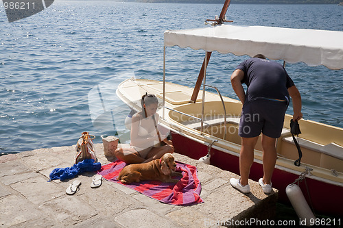 Image of Couple and dog by the sea