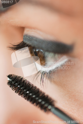 Image of Girl aplying eye make up