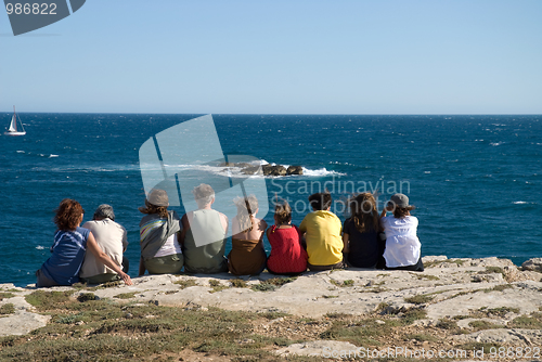 Image of Group of people sitting on beach
