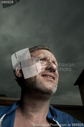 Image of expressive man doing a stress face