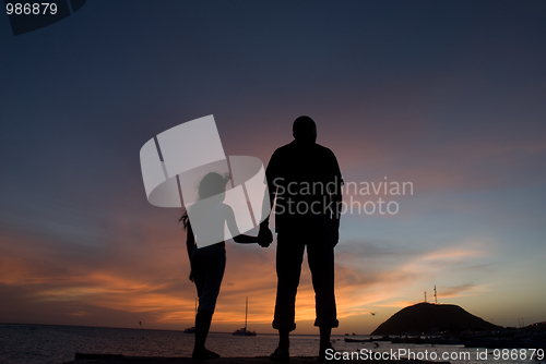 Image of Father and sun watching sunset