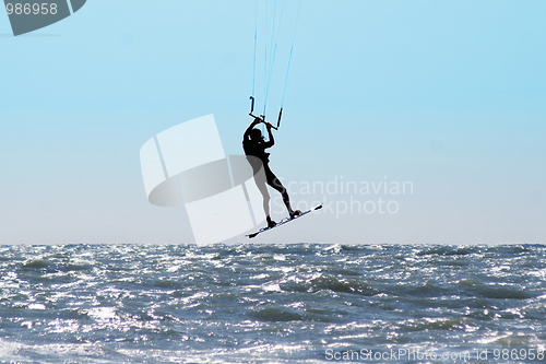 Image of Silhouette of kite surfer in a sea 