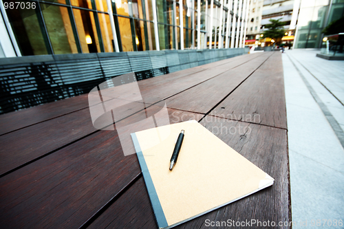 Image of book and pen on chair