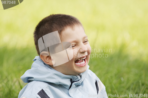 Image of Laughing little kid in grass