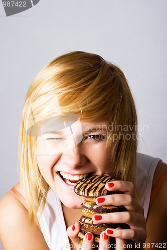 Image of woman eating chocolate chip cookies