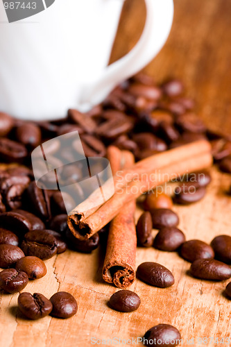 Image of coffee beans, cup and cinnamon 