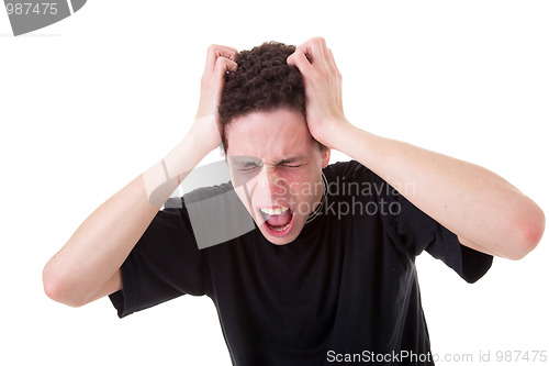 Image of Strongly afflicted young man, screaming and pulling hair