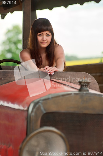 Image of Young woman with old car.