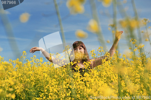 Image of Happy girl in flower meadow.