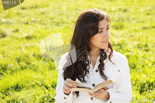 Image of Brunette in white with book