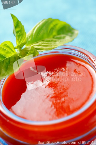 Image of Tomato sauce with basil leaves