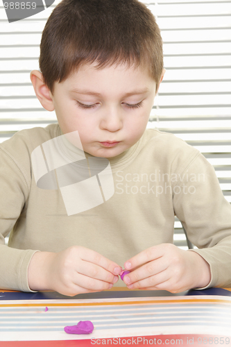 Image of Boy with plasticine