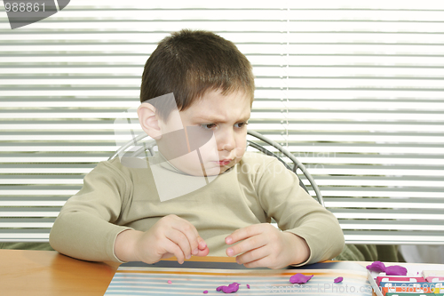 Image of Funny boy with plasticine