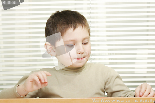 Image of Cute boy at desk