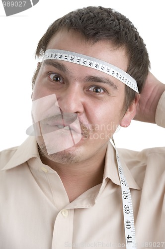 Image of man measuring his head