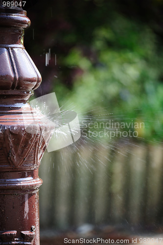 Image of Water splashing on a lamppost