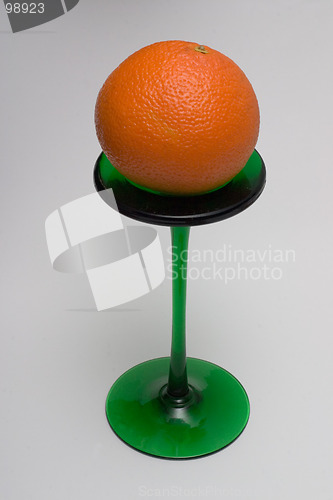 Image of Orange on a green stand