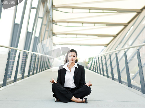Image of Black businesswoman meditating