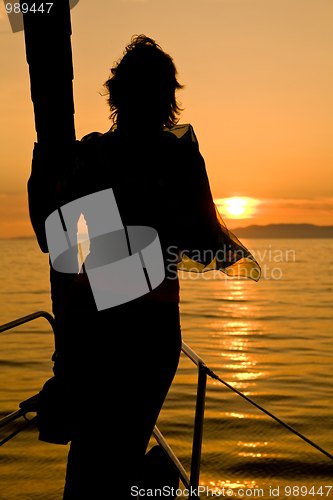 Image of woman silhouette on yacht nose