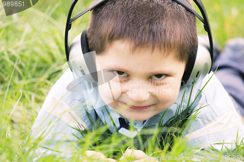 Image of Smiling boy in headphones outdoors