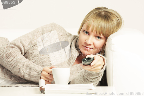 Image of Woman on sofa with remote control