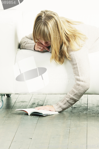 Image of Woman and book on floor