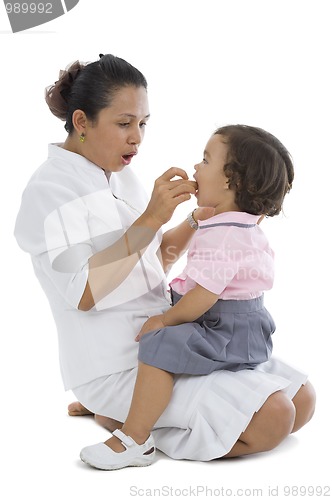 Image of mother feeding her little girl