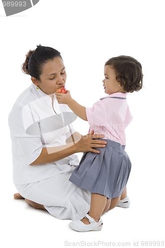 Image of cute girl feeding her mother