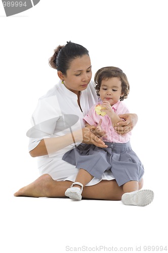 Image of mother with cute daughter eating an apple