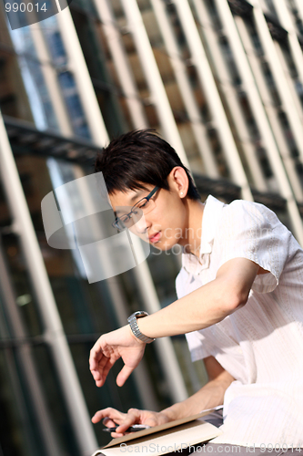 Image of handsome business man looking at watch 