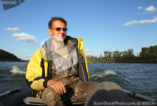 Image of men on boat with motor