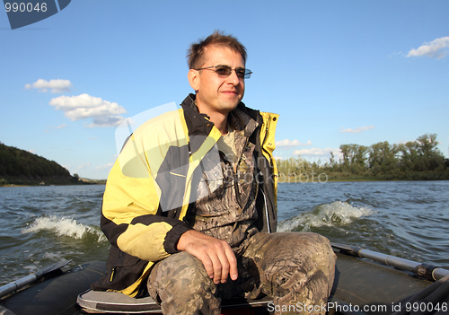 Image of men on boat with motor