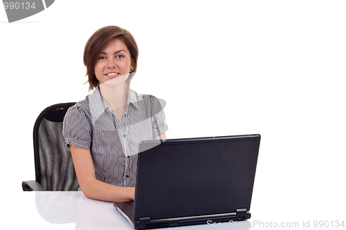 Image of  woman using laptop at work desk 