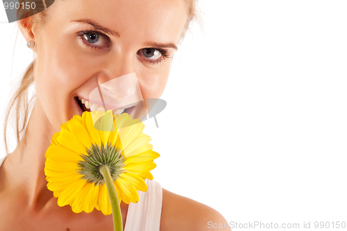 Image of woman smelling a yellow flower 