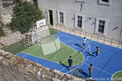 Image of Teens palying soccer