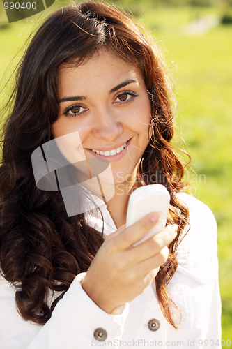 Image of Smiling woman with white cellphone