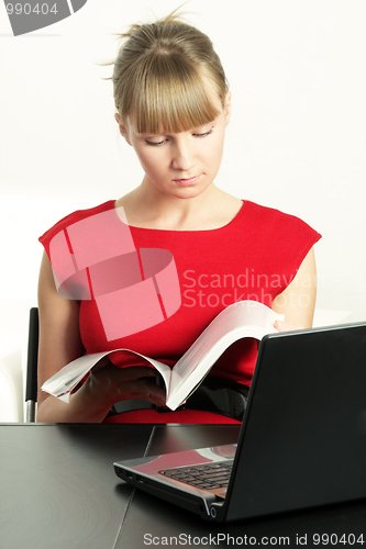Image of Blonde businesswoman with magazine