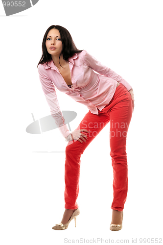 Image of Playful young brunette in red jeans