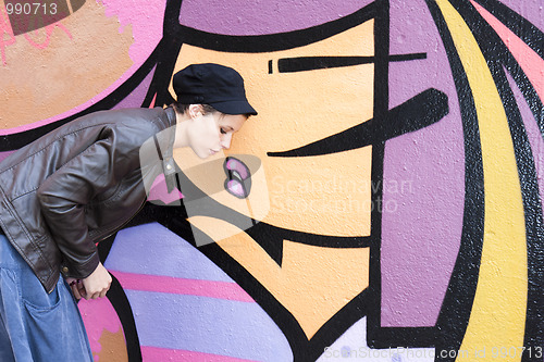 Image of  woman in front of a graffiti